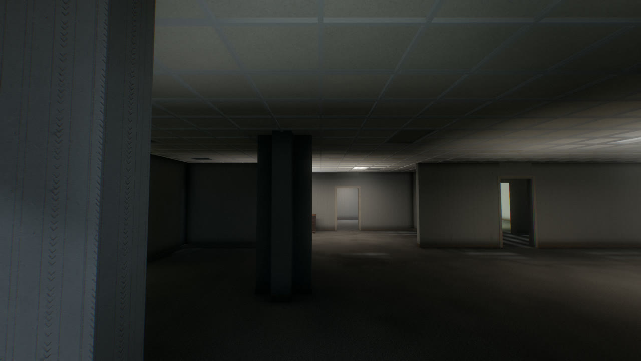 A dark open office with a lone pillar